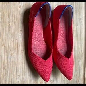 Rothy’s pointed toe flats in the color Flame